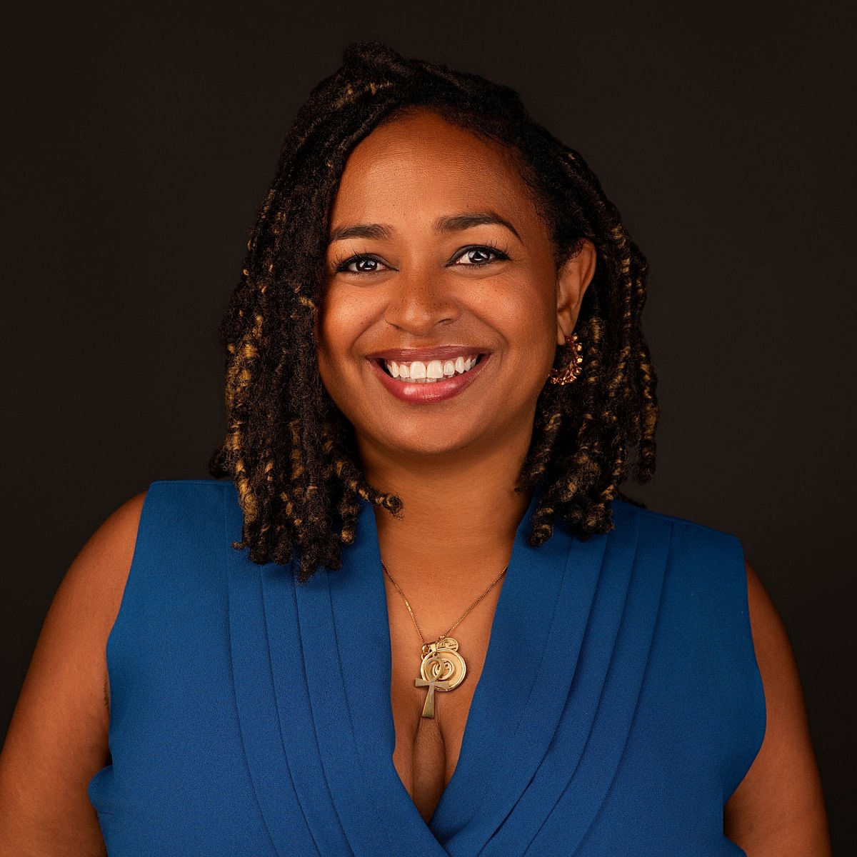 Portia M. Wood, Esq., smiling, in a blue dress